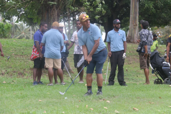 Ramu NiCo’s Community Affairs General Manager Erick Kuman making an assessment on the distance where his golf ball going to land before he takes a whack.